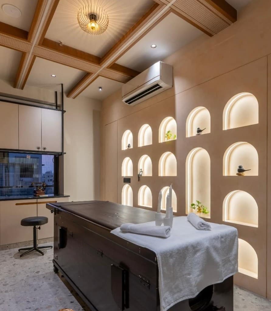 Panchkarma treatment room with lit arched niches at Shashvat Ayurveda